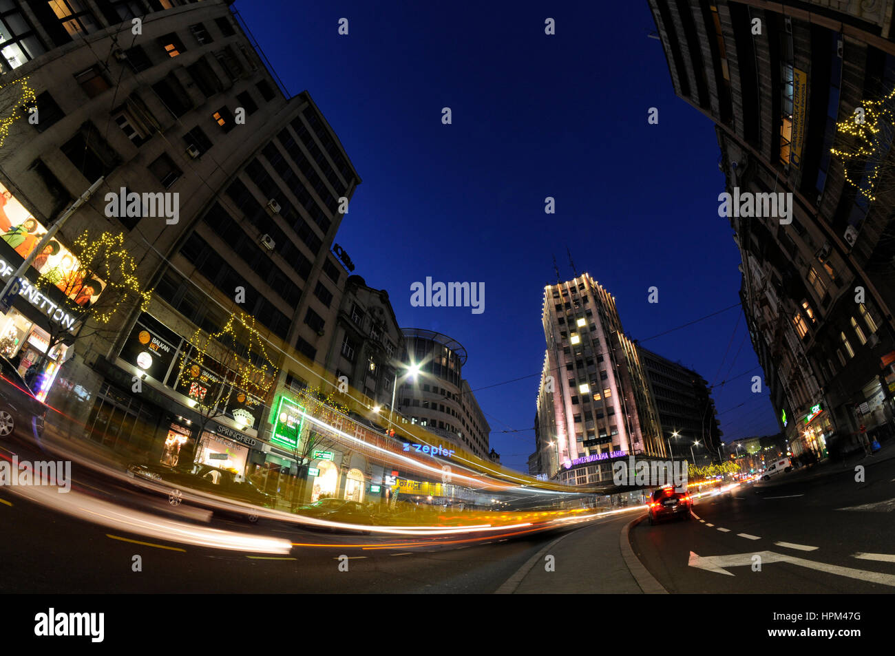 Belgrade, Serbia, city center view from Terazije to Knez Mihajlova street with Albania Palace building in middle with lighttrails from passing traffic Stock Photo