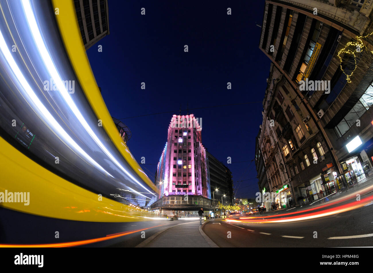 Belgrade, Serbia, city center view from Terazije to Knez Mihajlova street with Albania Palace building in middle with lighttrails from passing traffic Stock Photo