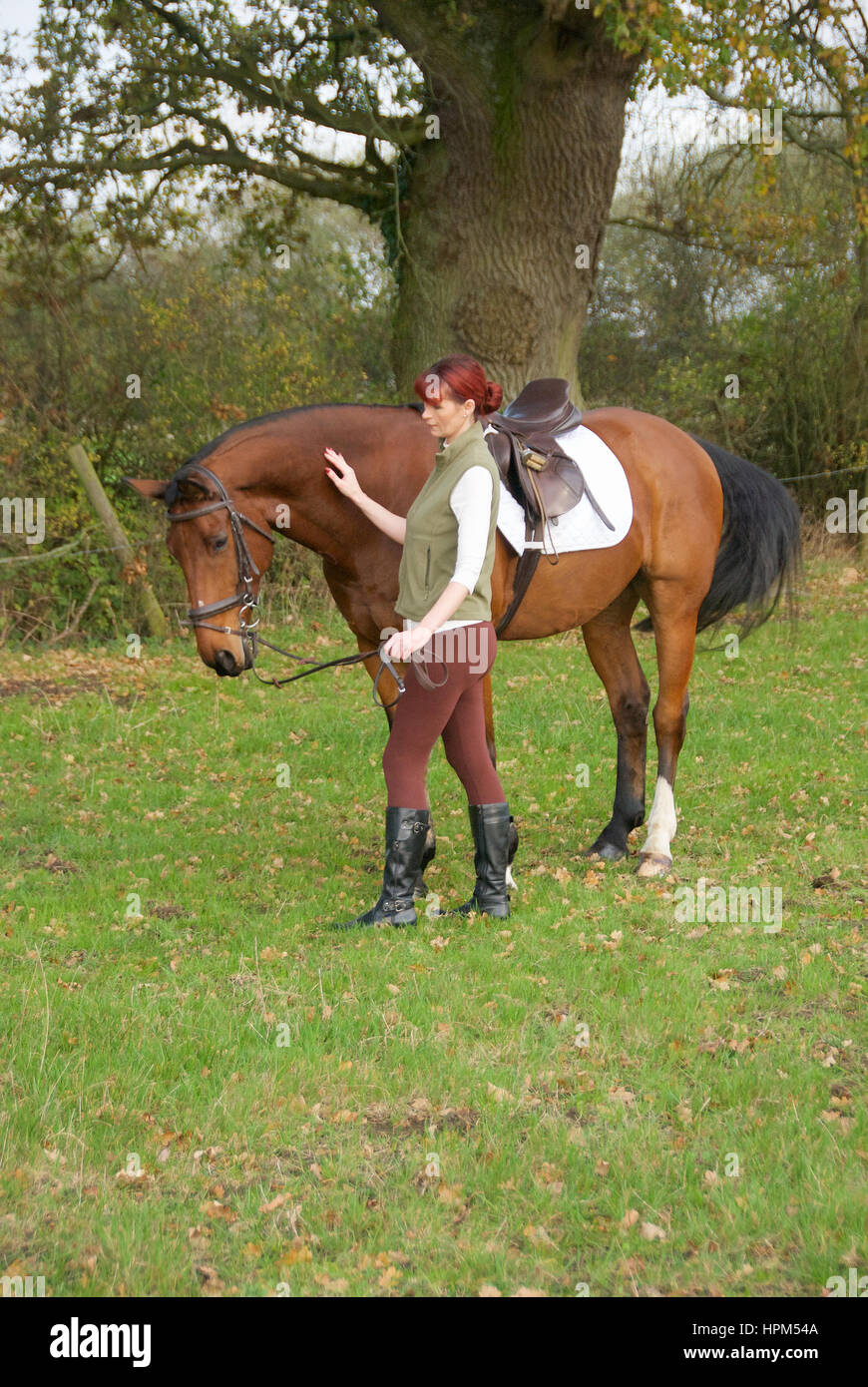 Beautiful woman in the countryside wearing jodhpurs and jacket and a
