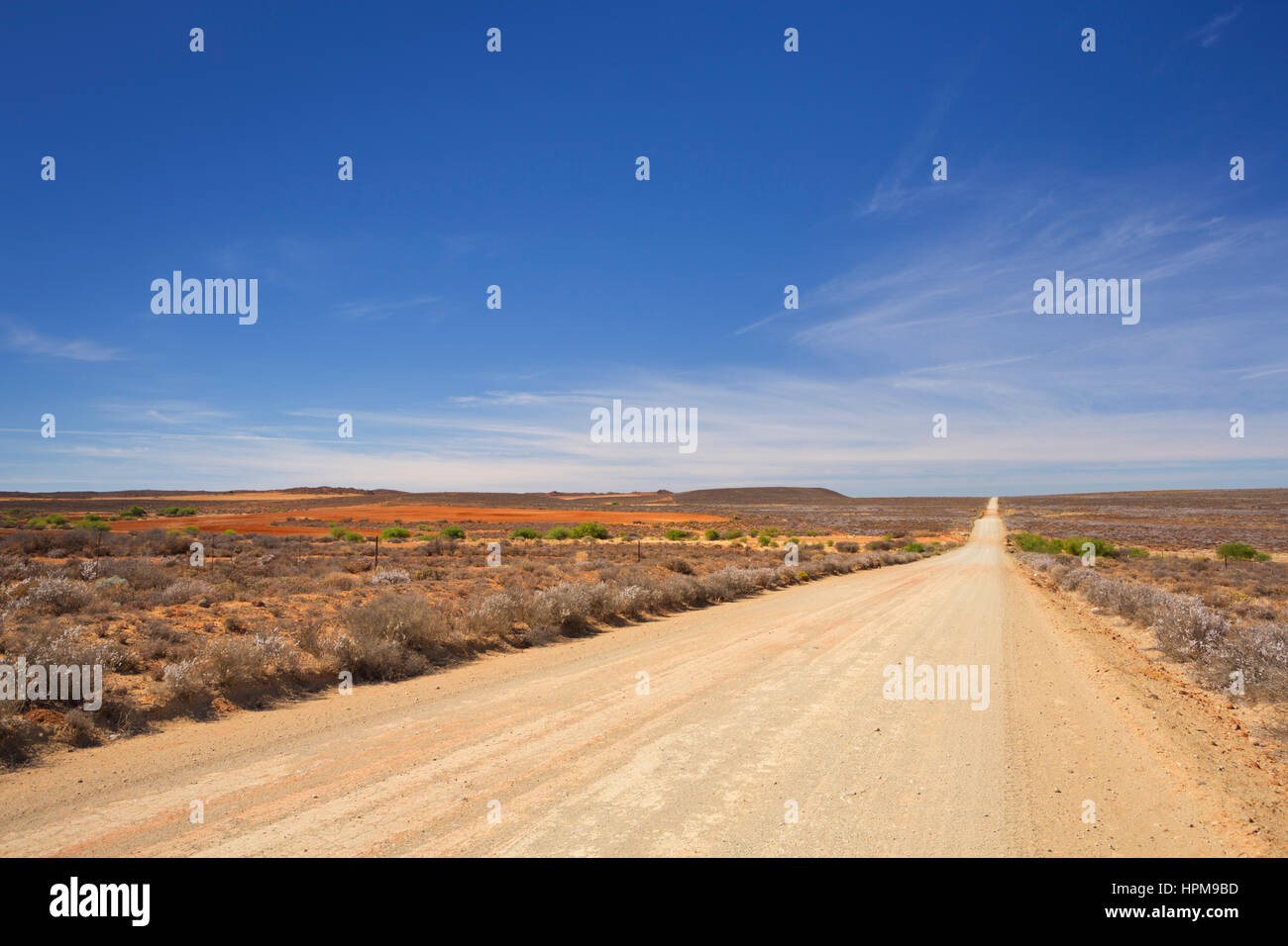 A straight dirt road through the dry Karoo semi-desert in South Africa. Stock Photo