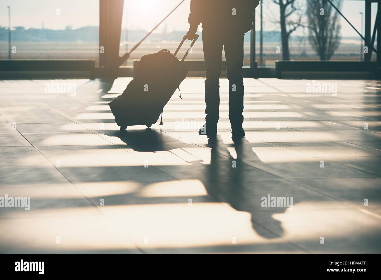 Shadow of the traveler with luggage at the airport. Stock Photo