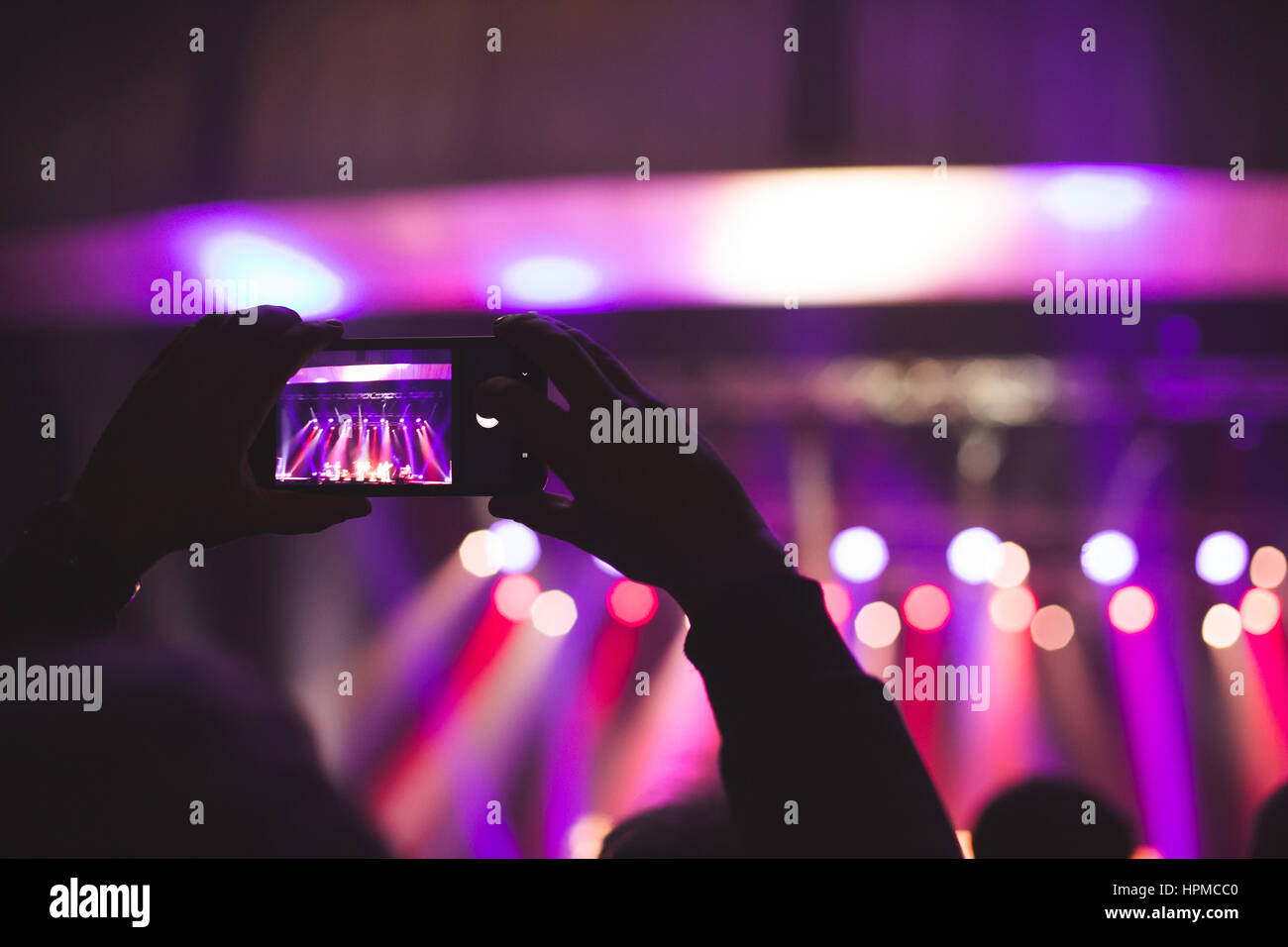 The audience watching the concert on stage Stock Photo - Alamy