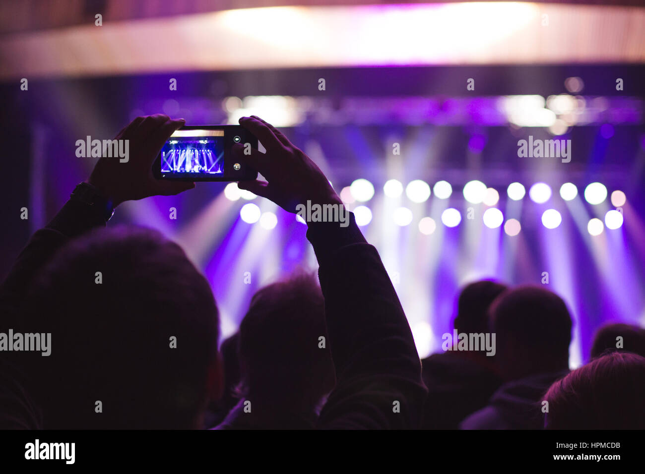 The audience watching the concert on stage Stock Photo - Alamy