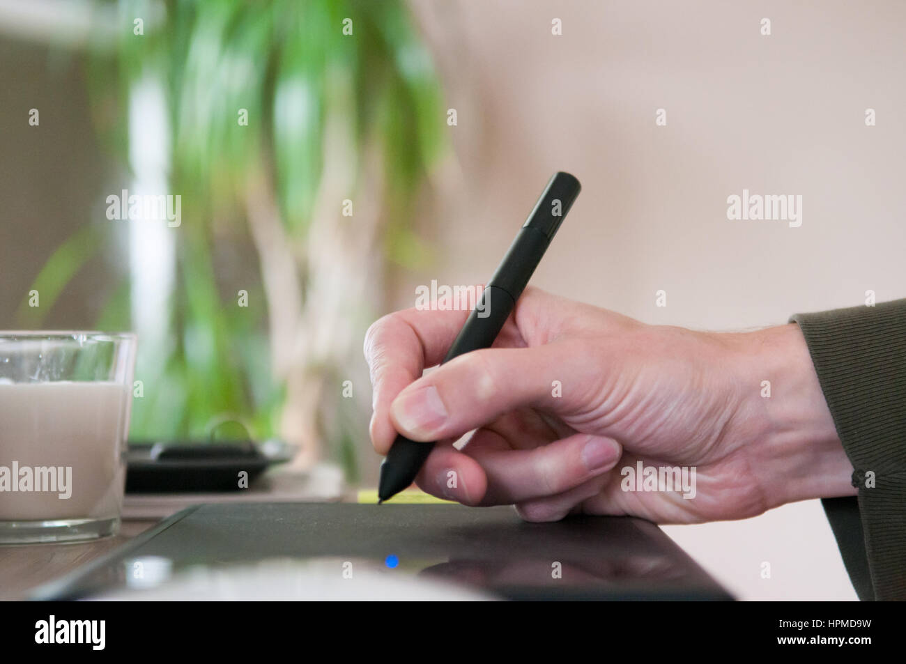 Graphic designer using a drawing graphics tablet Stock Photo - Alamy