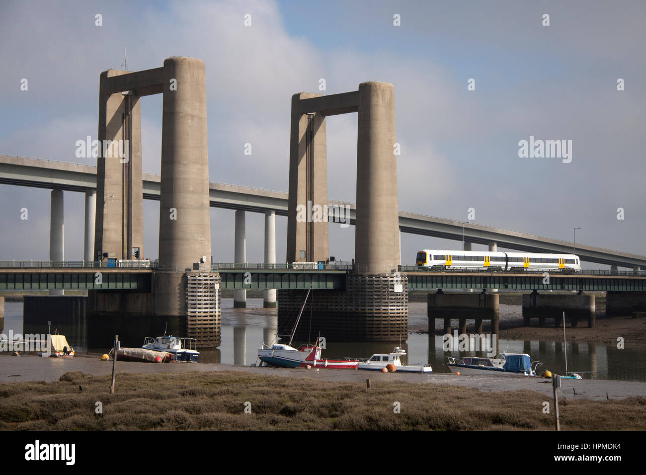 A train crossing the Kingsferry Bridge which is a combined road and railway vertical-lift bridge connecting the Isle of Sheppey with mainline Kent. Stock Photo