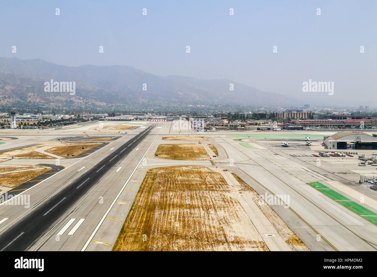 Burbank, USA - May 27, 2015: Aerial view of the airport with runways, a hangar and parked airplanes. Stock Photo