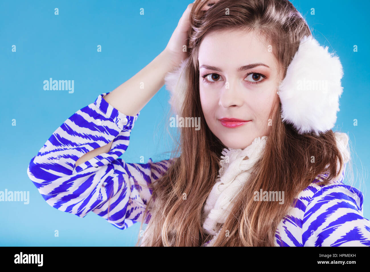 Smiling teenage girl wearing fluffy white earmuff in winter fashion