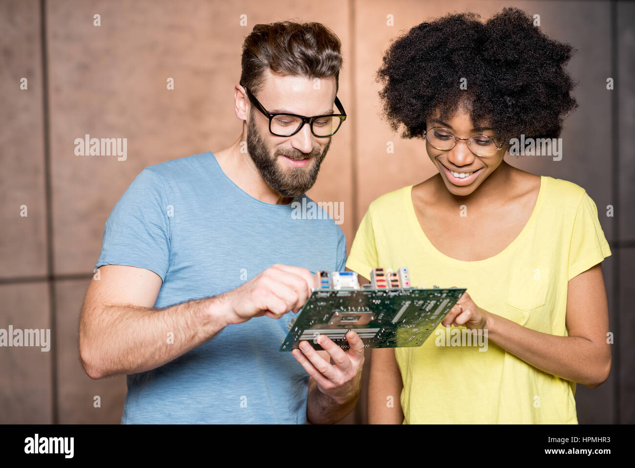 Programmers with computer motherboard Stock Photo - Alamy