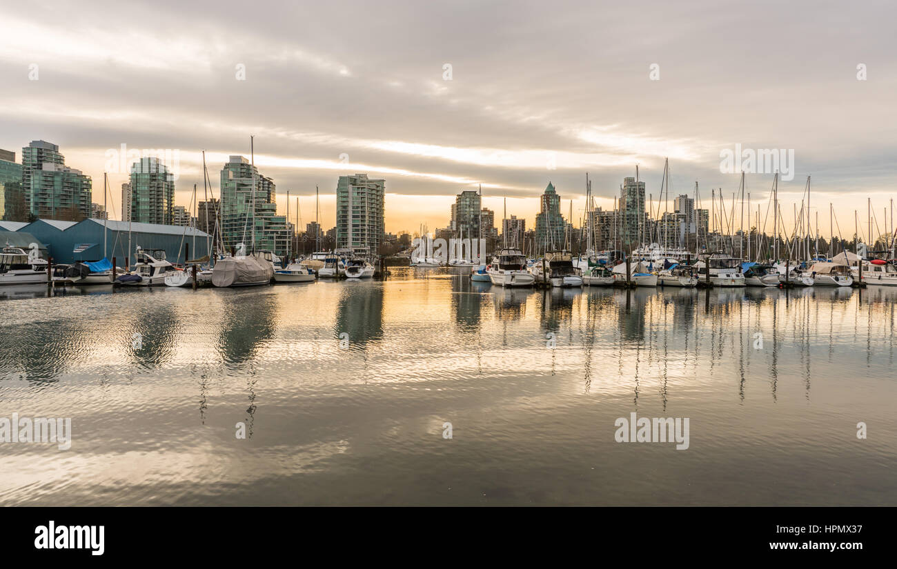 Vancouver, Canada - January 28, 2017: Vancouver city skyline with boats in harbour at sunset Stock Photo