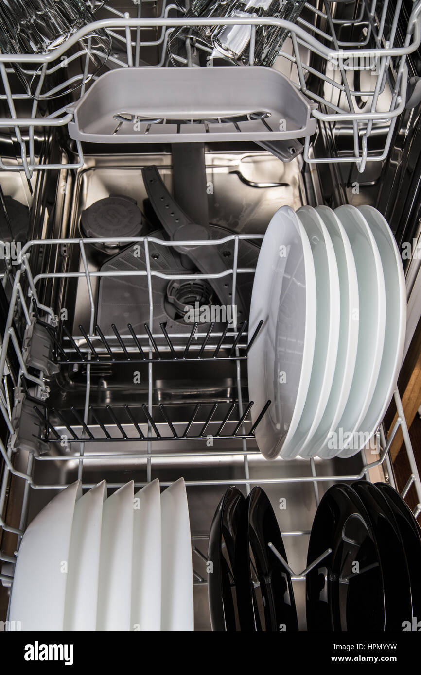 Clean dishes in a modern dishwasher machine Stock Photo
