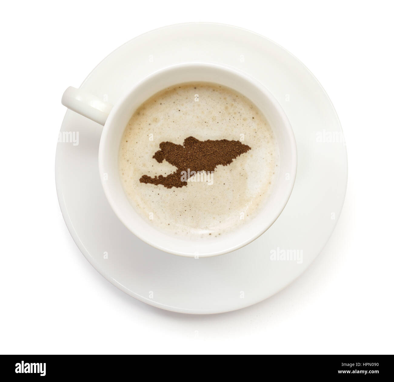 A cup of coffee with foam and powder in the shape of Kyrgyzstan.(series) Stock Photo