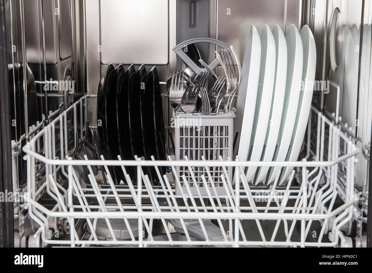 Clean dishes after washing in modern dishwasher machine Stock Photo Alamy
