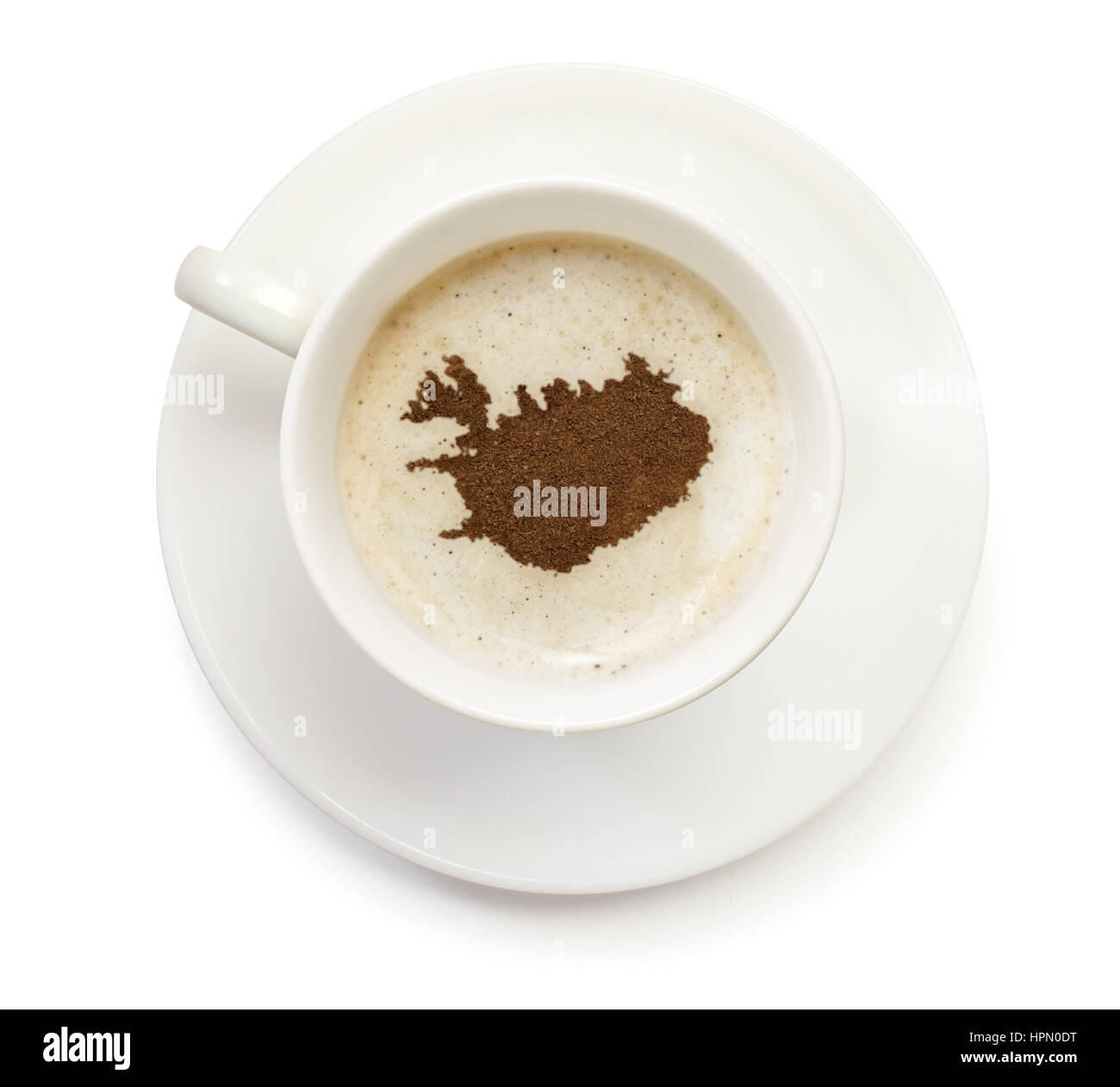 A cup of coffee with foam and powder in the shape of Iceland.(series) Stock Photo