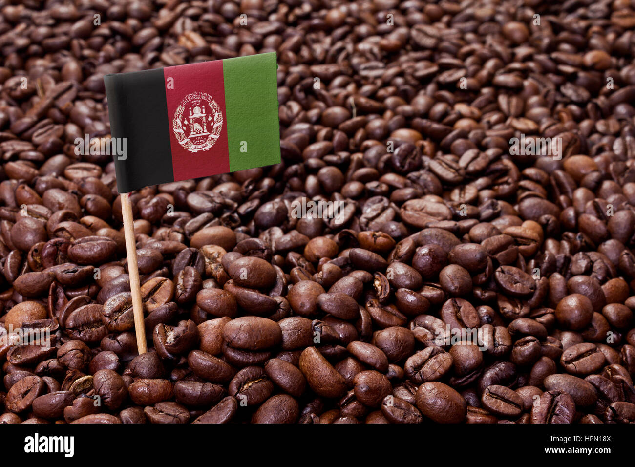 Flag of Afghanistan sticking in roasted coffee beans.(series Stock