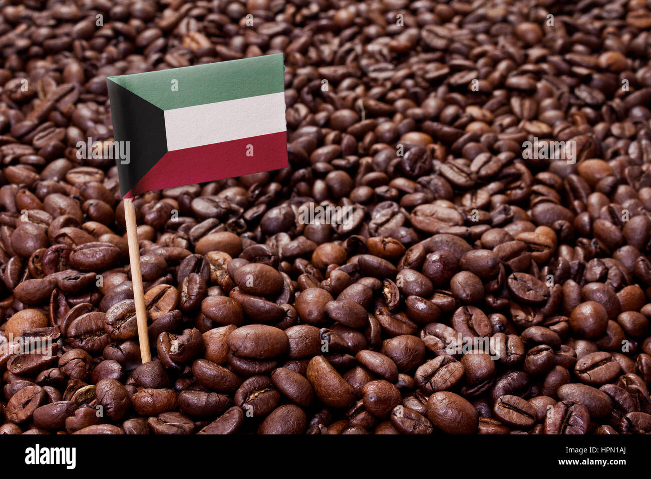 Flag of Kuwait sticking in roasted coffee beans.(series) Stock Photo