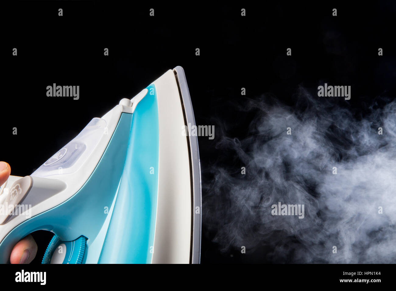 Modern iron and steam isolated on black background Stock Photo Alamy