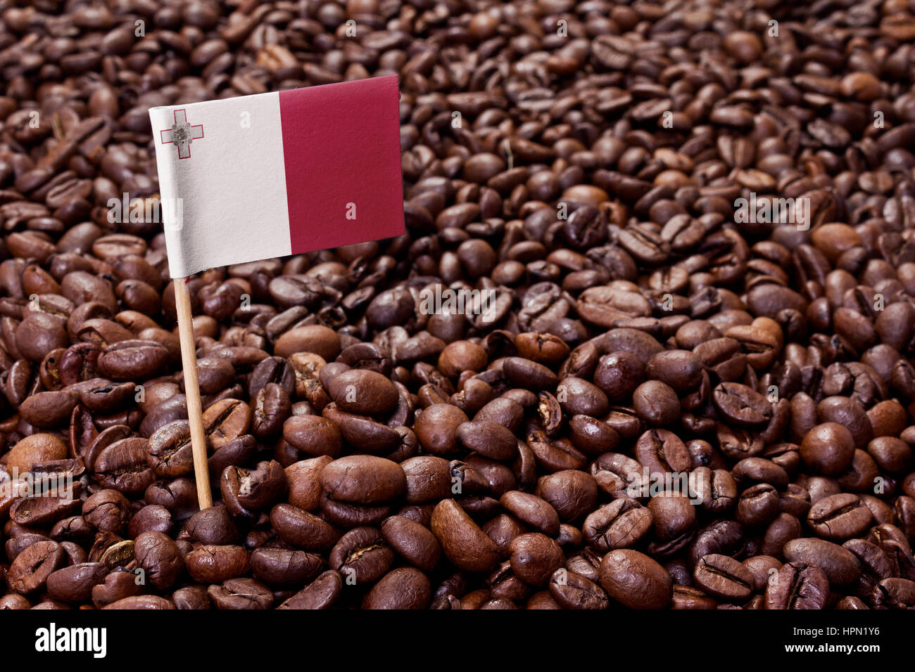 Flag of Malta sticking in roasted coffee beans.(series Stock Photo Alamy