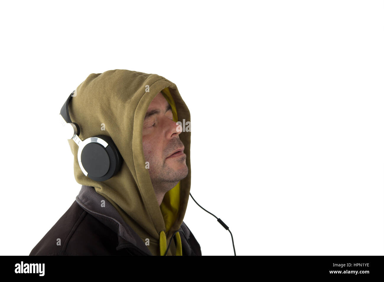 Man In Hoodie Listening To Music On Headphones Stock Photo - 