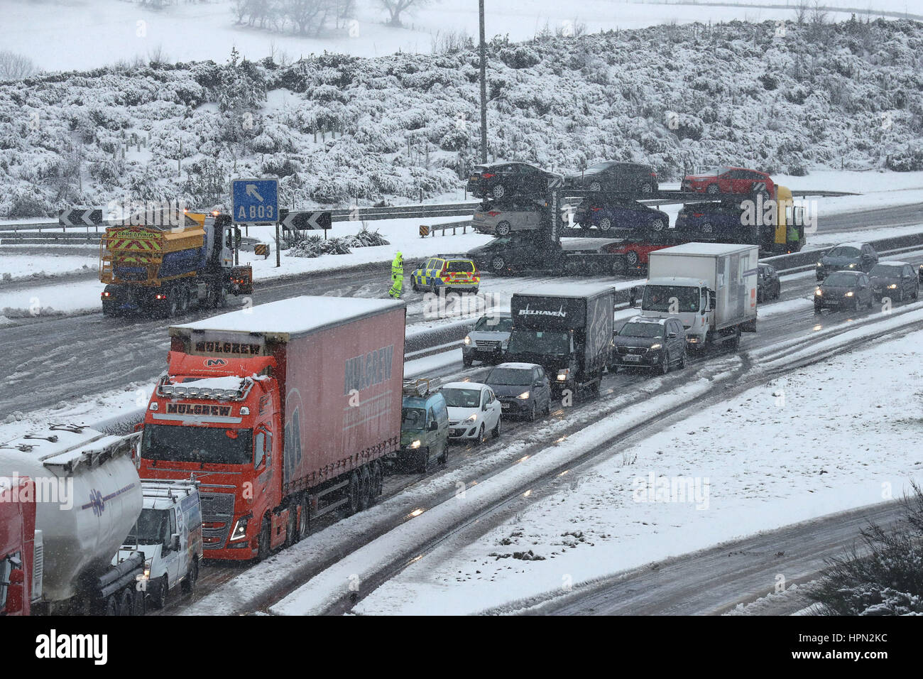 A jack-knifed car transporter on the M80 near Banknock during early morning snowfall, as flights have been cancelled and commuters were warned they faced delays after Storm Doris reached nearly 90mph on its way to batter Britain. Stock Photo