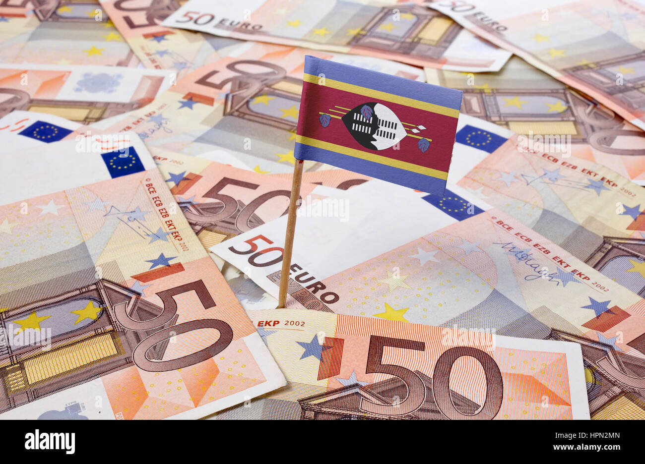 Flag of Swaziland sticking in european banknotes.(series) Stock Photo