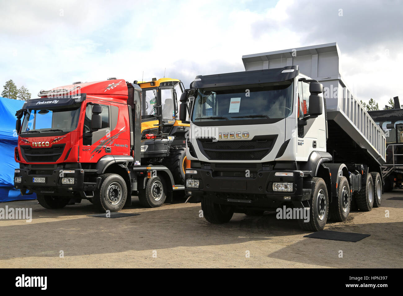 JAMSA, FINLAND - SEPTEMBER 2, 2016: Red and white new Iveco Trakker 500 trucks on display on the heavy machinery exhibition FinnMETKO 2016. Stock Photo