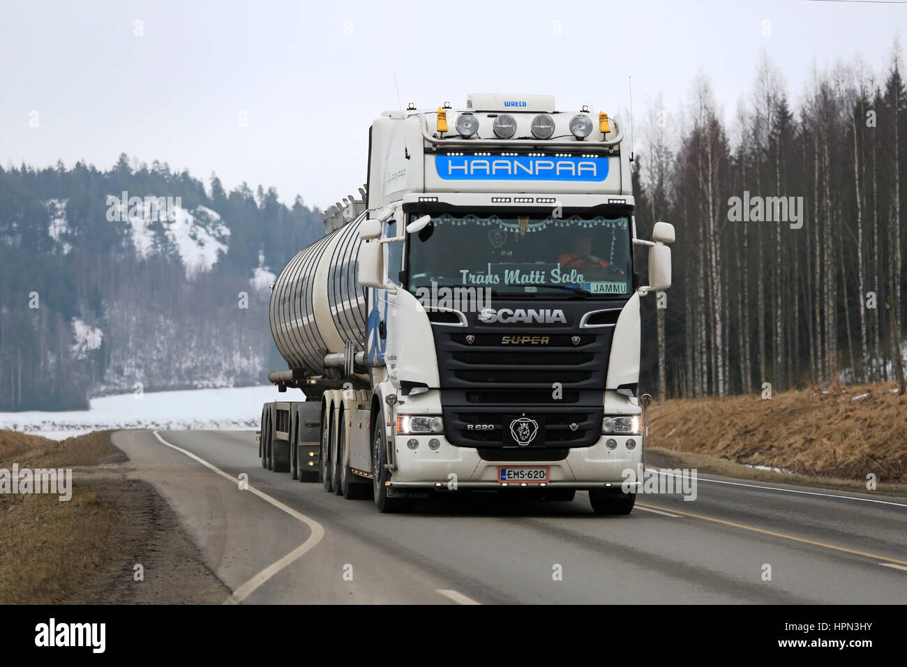 SALO, FINLAND - MARCH 13, 2016: White super Scania R620 tank truck for bulk transport of Trans Matti Salo for Haanpaa moves along highway at spring in Stock Photo