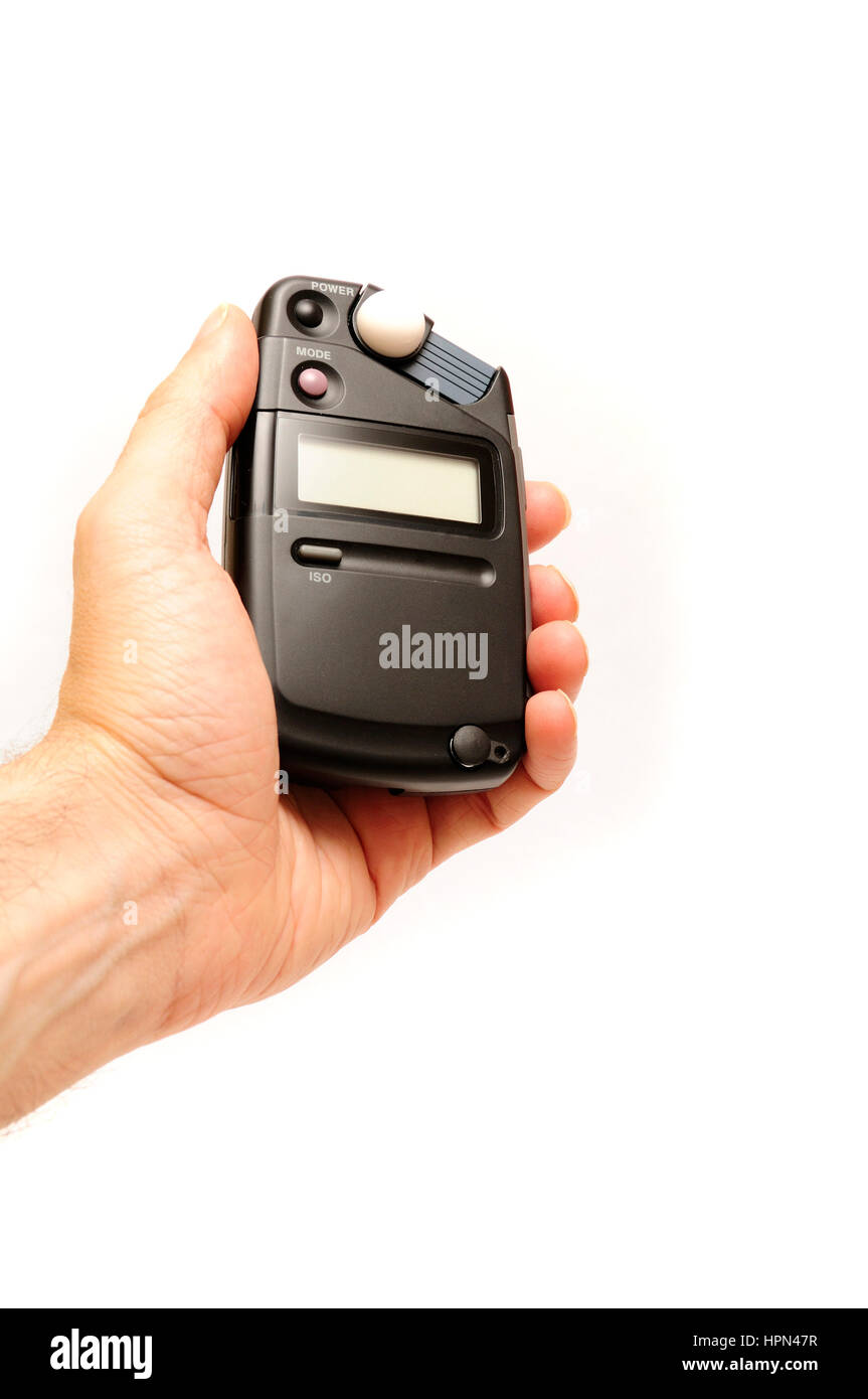 male hand holding a professional photographic light meter Stock Photo