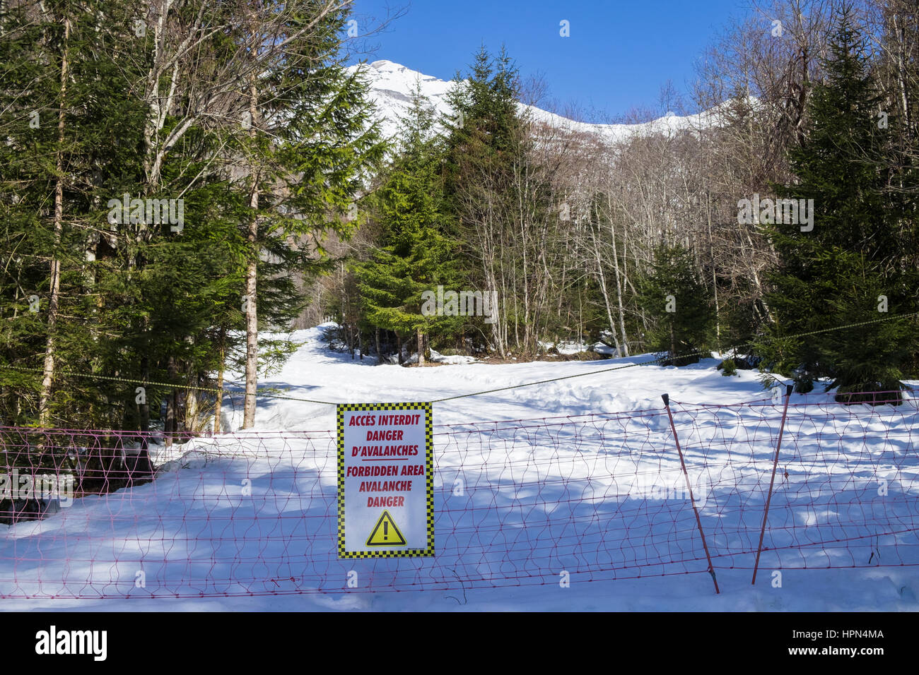 Avalanche warning sign on closed path in Reserve Naturelle de Sixt Fer A Cheval in Le massif du Giffre in French Alps. Haute Savoie Rhone-Alpes France Stock Photo