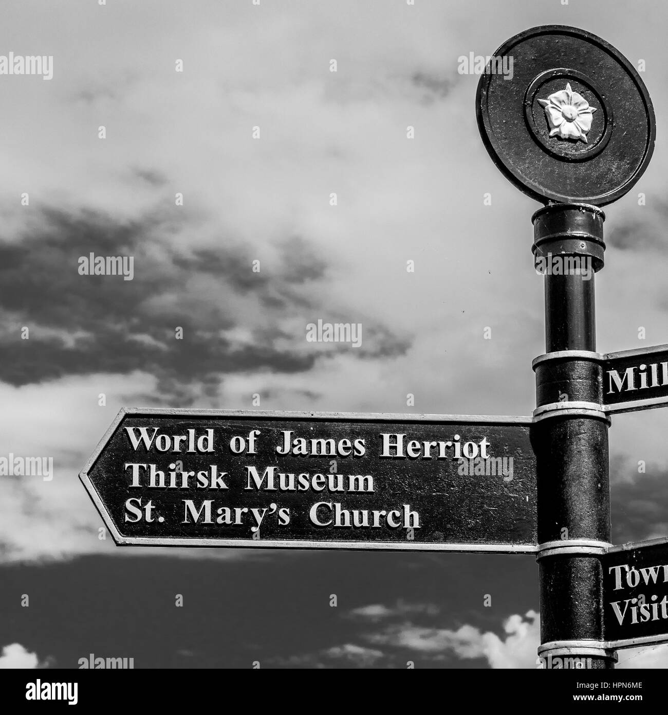 Signpost to World of James Herriot, Thirsk museum, and St. Mary's Church, Thirsk, North Yorkshire, UK. Stock Photo