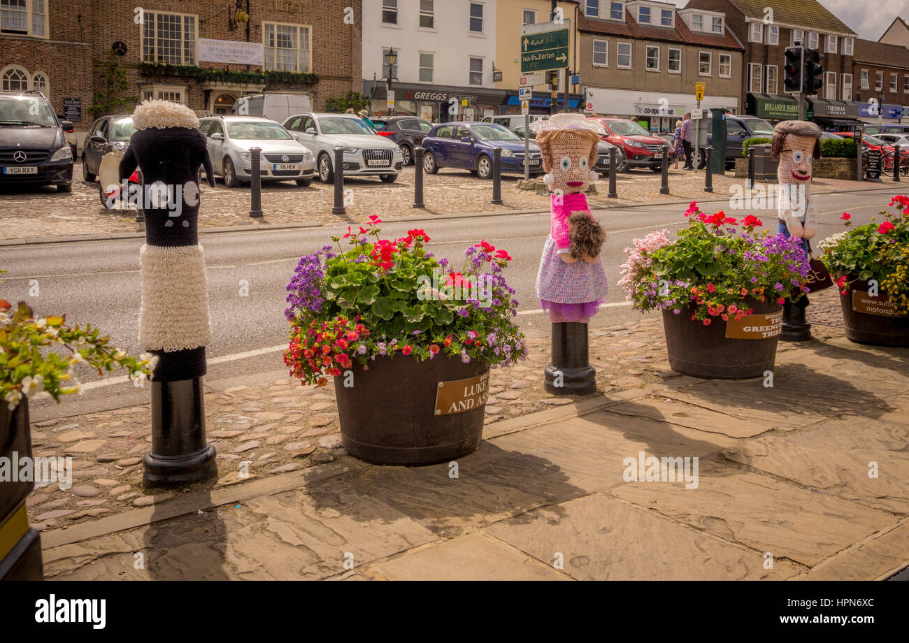 Knitted figures in Market Square, Thirsk, North Yorkshire, UK. Stock Photo