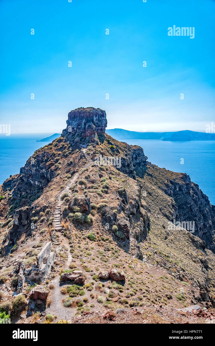 A view of santorini overlooking the rock of skaros with the volcano in the background. Stock Photo