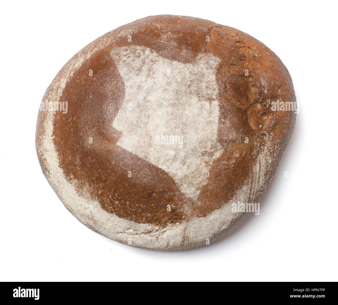 A freshly baked loaf of bread covered with rye flour in the shape of