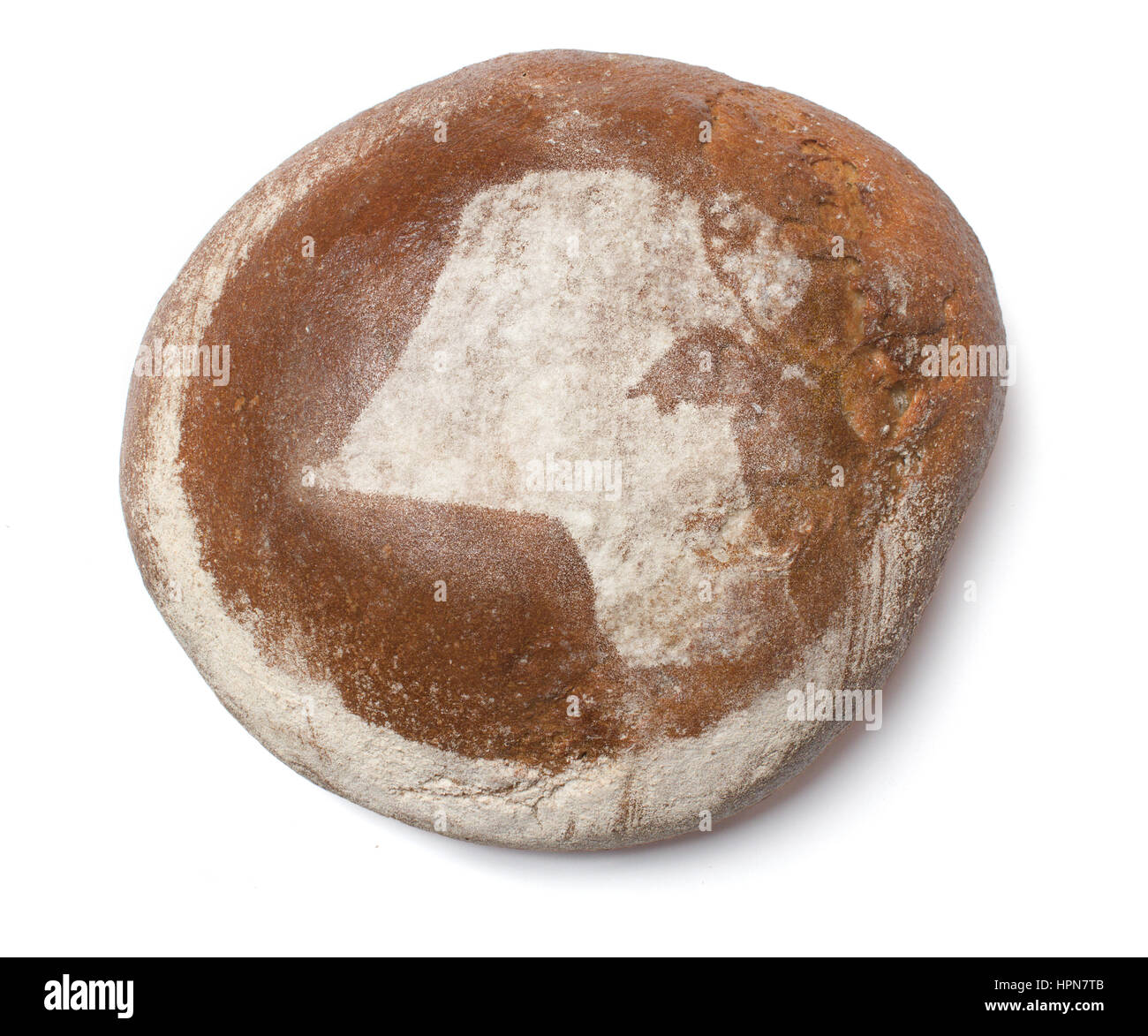 A freshly baked loaf of bread covered with rye flour in the shape of Kuwait.(series Stock Photo