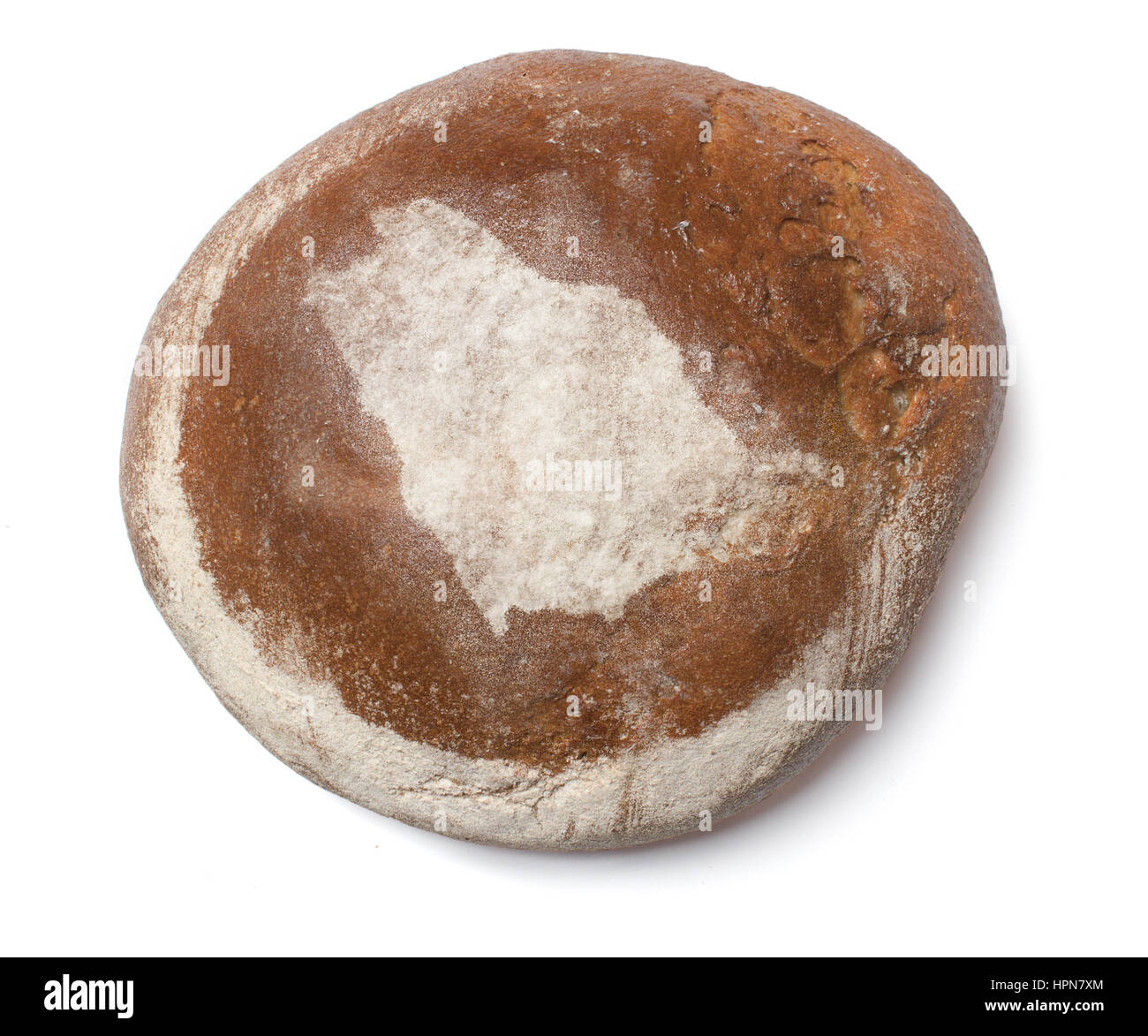 A freshly baked loaf of bread covered with rye flour in the shape of