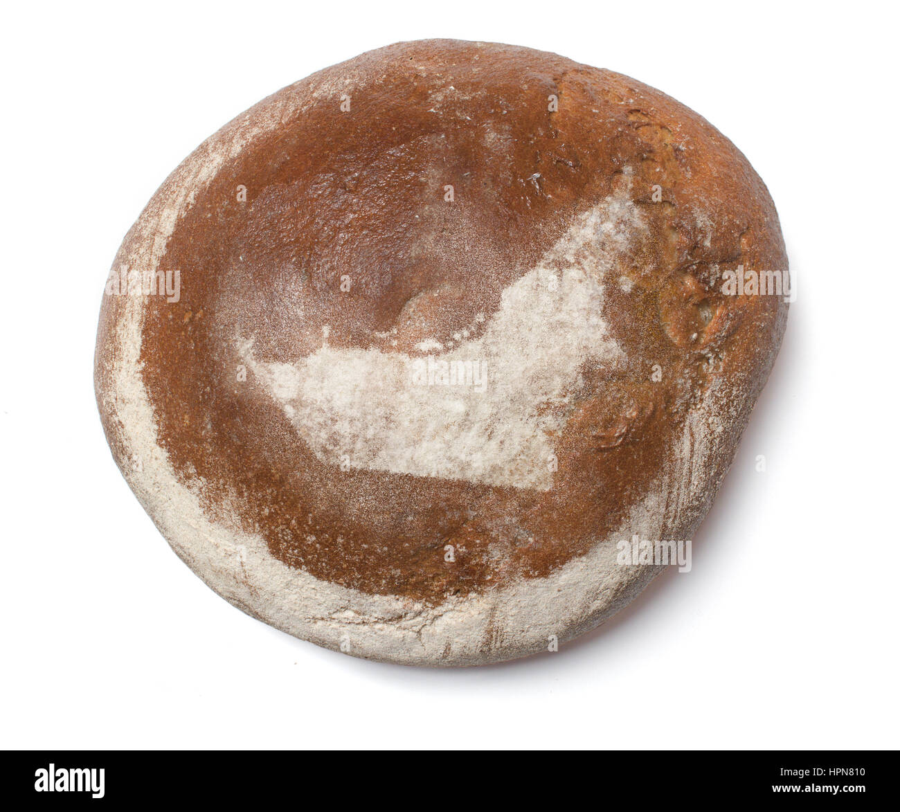 A freshly baked loaf of bread covered with rye flour in the shape of