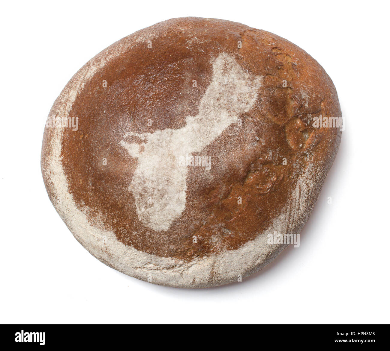 A freshly baked loaf of bread covered with rye flour in the shape of Guam.(series Stock Photo
