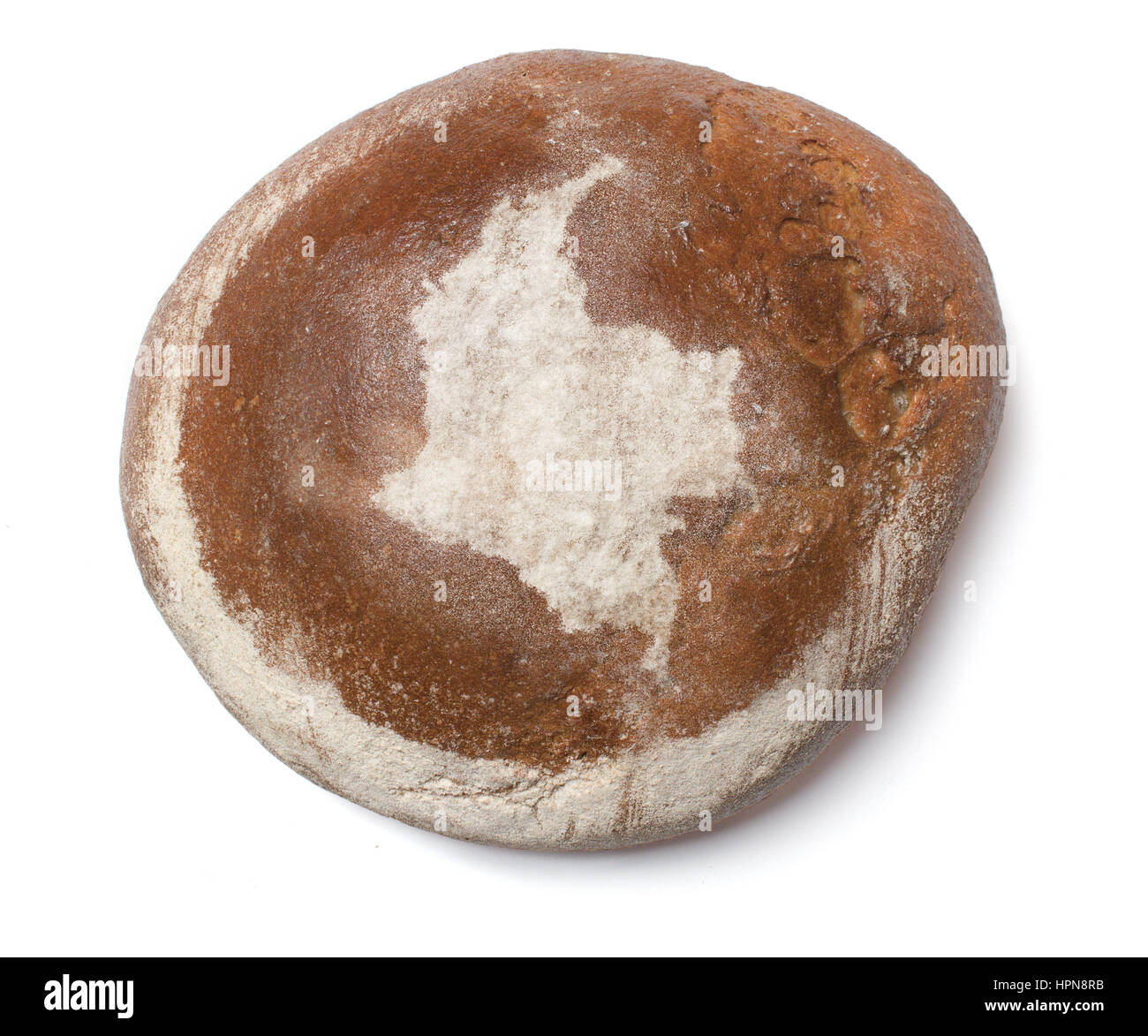 A freshly baked loaf of bread covered with rye flour in the shape of