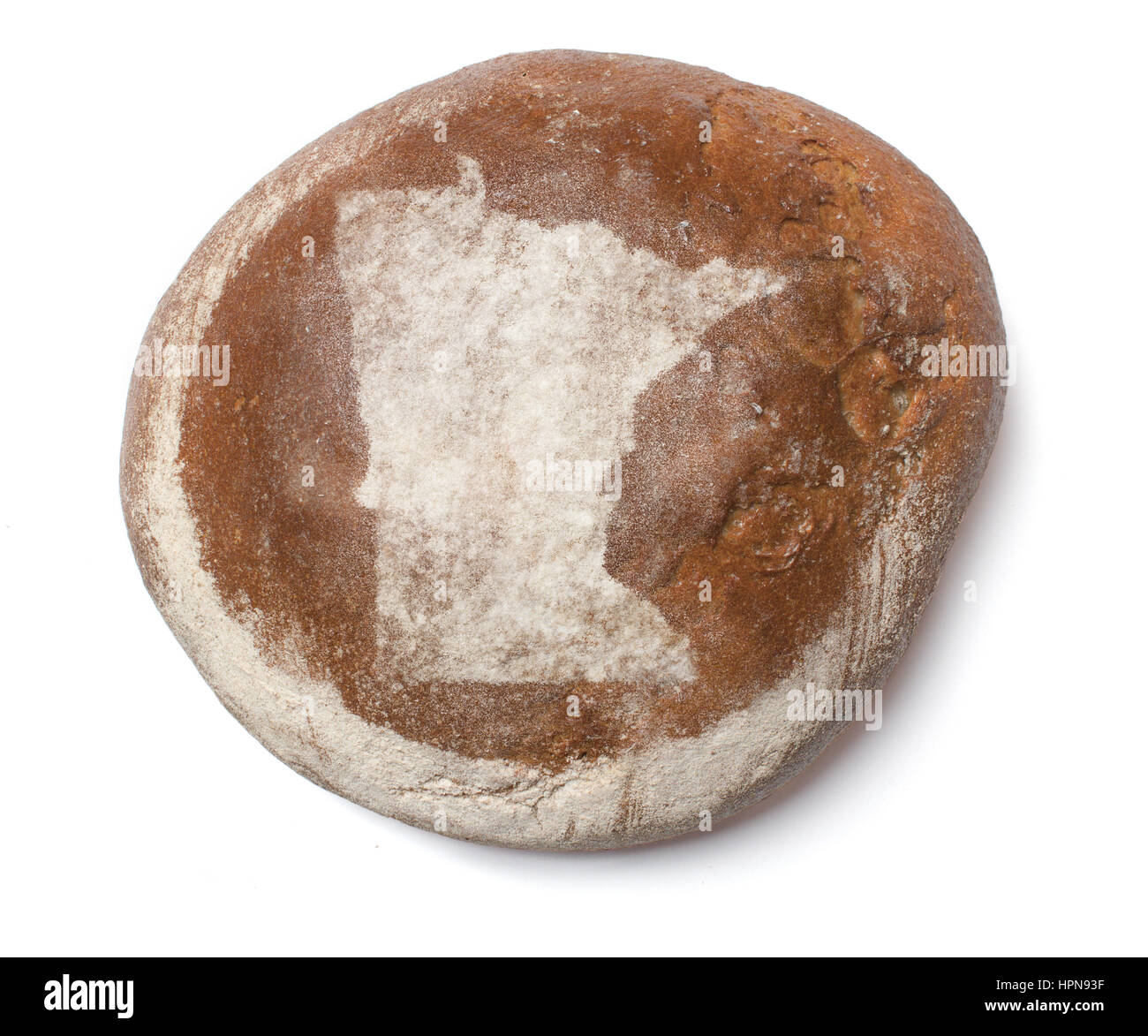 A freshly baked loaf of bread covered with rye flour in the shape of