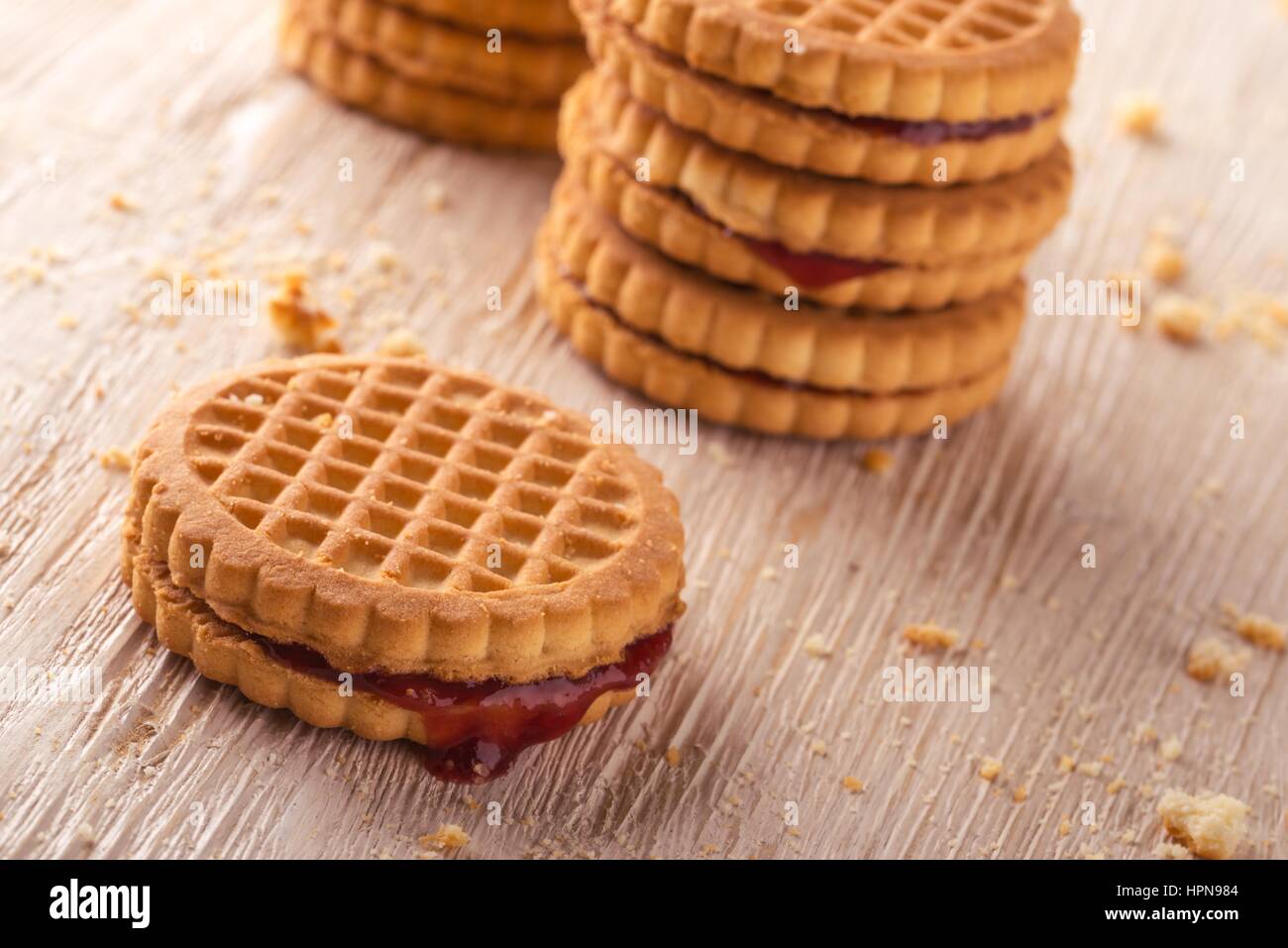 Horizontal photo of several stacks of golden biscuits. Biscuits are