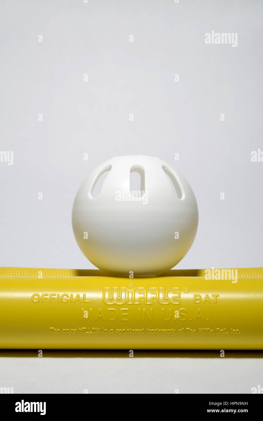 Wiffle ball and bats.  Made by The Wiffle Ball Inc.  Invented by the Mullany family of Connecticut.  They have registered a particular shade of yellow Stock Photo