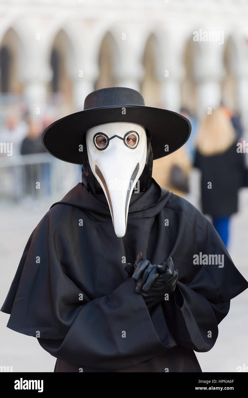 The traditional costume and mask of the Medico Della Peste seen in front of the Doge's Palace during the 2017 venice carnival Stock Photo