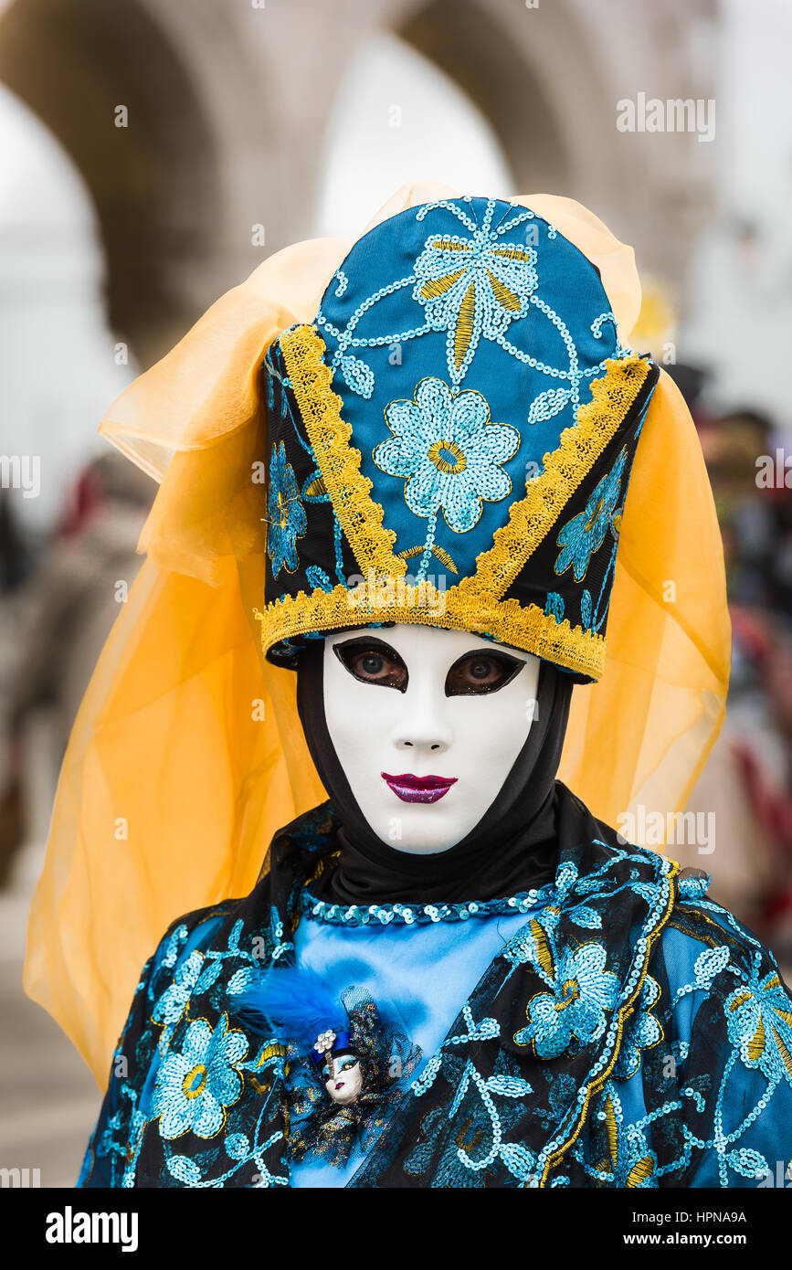 A woman is seen outside the Doge's Palace wearing a traditional Volto mask during the 2017 Venice Carnival Stock Photo