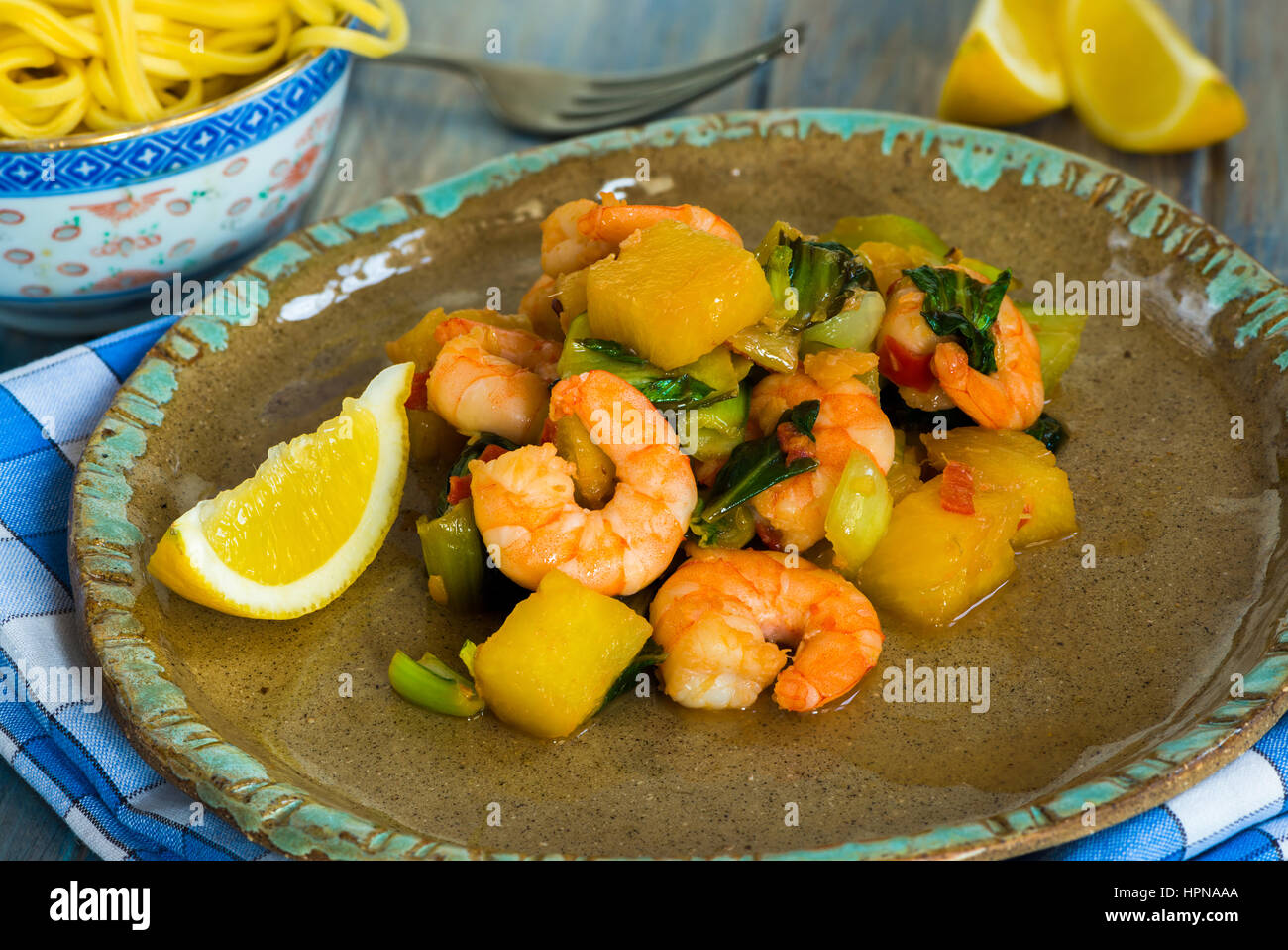 Prawn and pineapple stir fry with pak choi and noodles Stock Photo Alamy