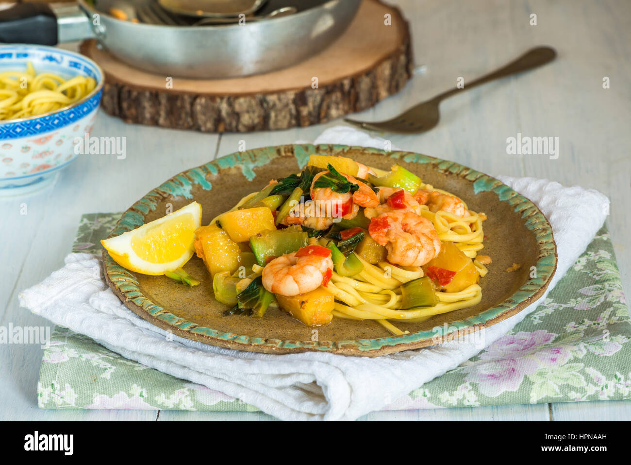 Prawn and pineapple stir fry with pak choi and noodles Stock Photo Alamy