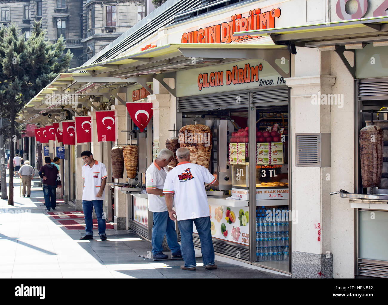 Turkish doner, kebap and hamburger places in the begining of Istiklal and Siraselviler avenues at Taksim square. Workers get ready for busy night. Tur Stock Photo