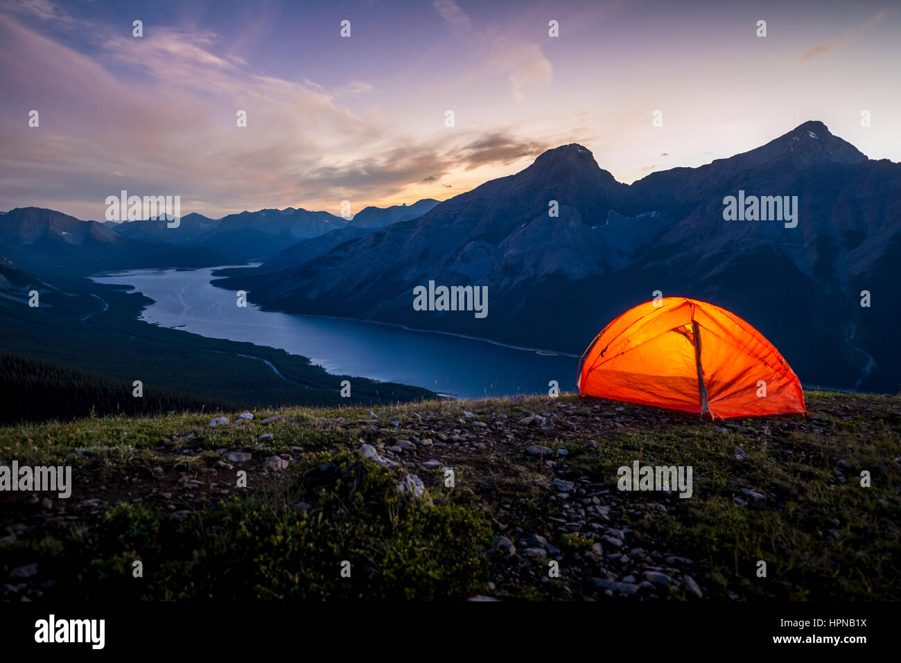 Glowing tent set up on a ridge for camping in the Rocky mountains Stock ...