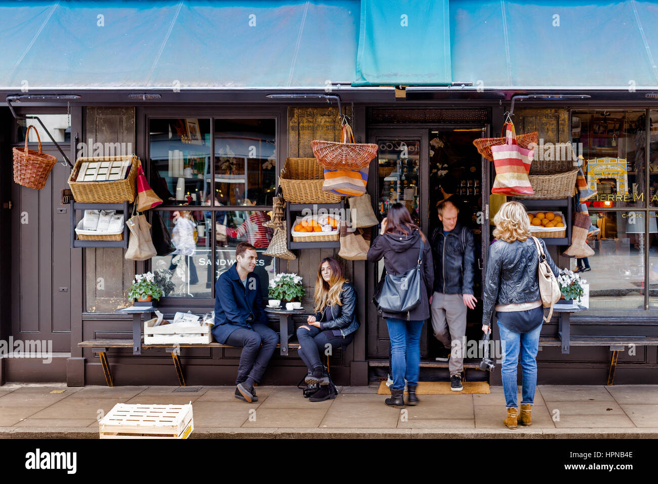 London, United Kingdom - April 5, 2015. Brushfield St. Bistro & Delicatessen bar in front of Spitafields Market. People having coffee at the terrace. Stock Photo