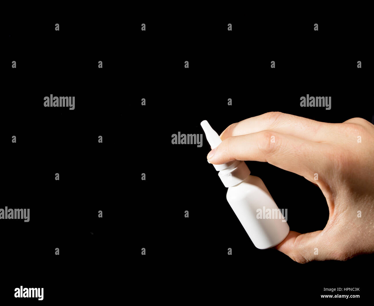 White bottle of nasal spray on black background Stock Photo