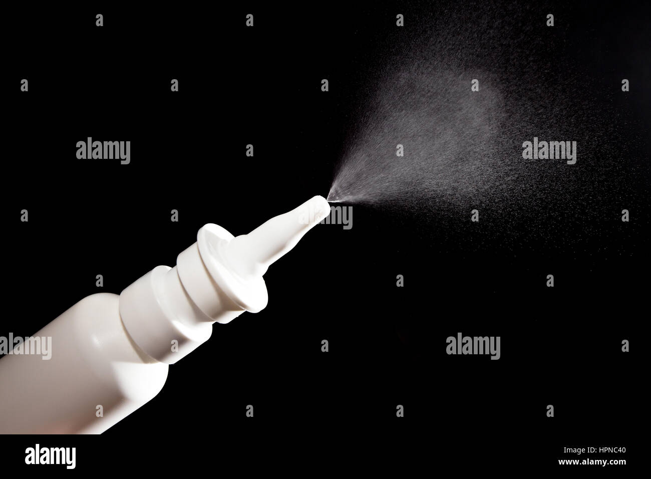 Close-up of nasal drug spraying on black background Stock Photo
