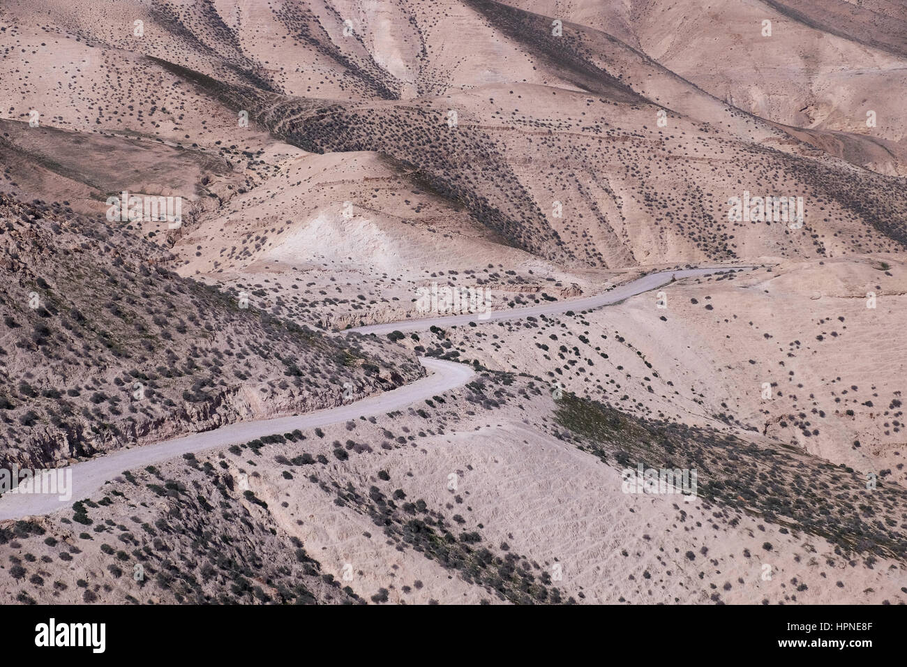 View of empty winding road leading to Wadi Qelt also Wadi Kelt or Nahal Prat (Hebrew) a valley at the Judaean or Judean desert in the West Bank, originating near Jerusalem and terminating near Jericho. Israel Stock Photo